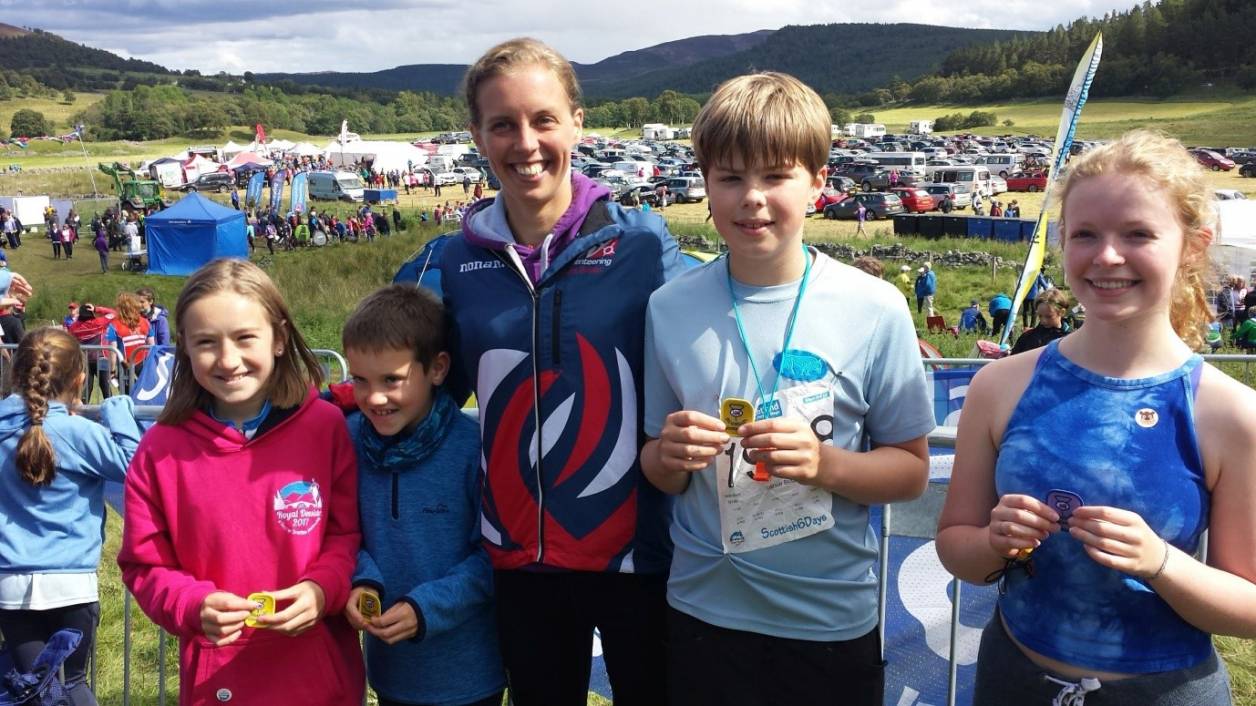 Juniors receiving participation badges from Jessica Tullie (GBR elite orienteer).Photo kindly supplied by Moravian Orienteering Club